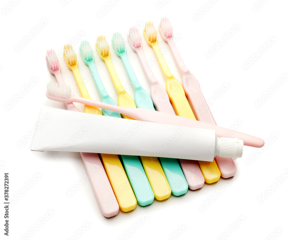 Tooth brushes and paste on white background