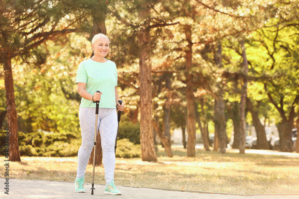 Mature woman with walking poles outdoors