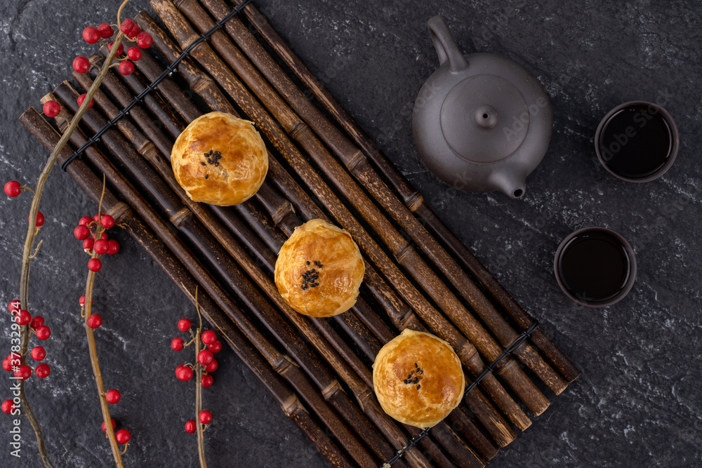 Moon cake yolk pastry, mooncake for Mid-Autumn Festival holiday, top view design concept on dark woo