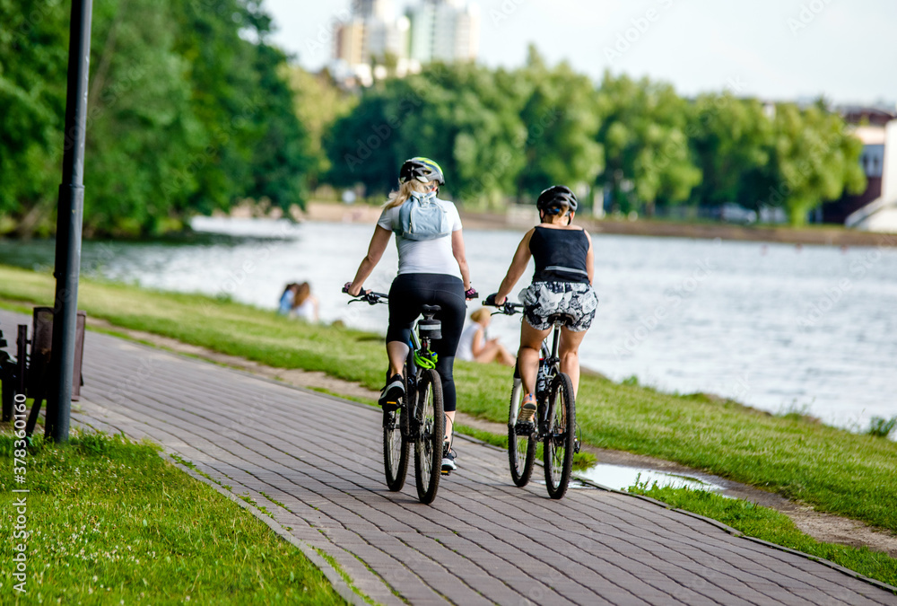 Cyclists ride on the bike path in the city Park
