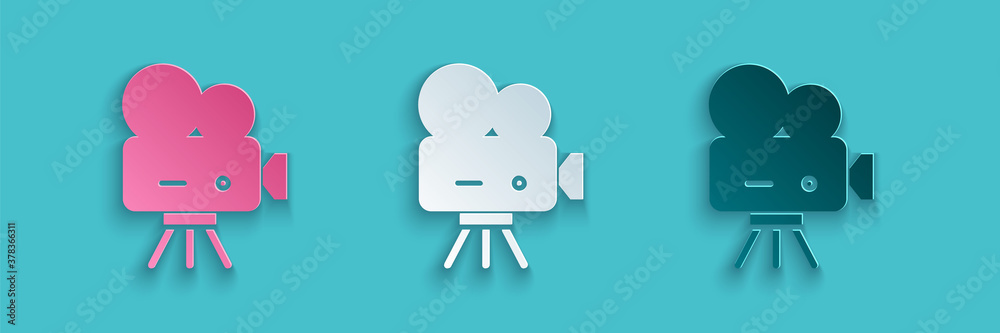 Paper cut Retro cinema camera icon isolated on blue background. Video camera. Movie sign. Film proje