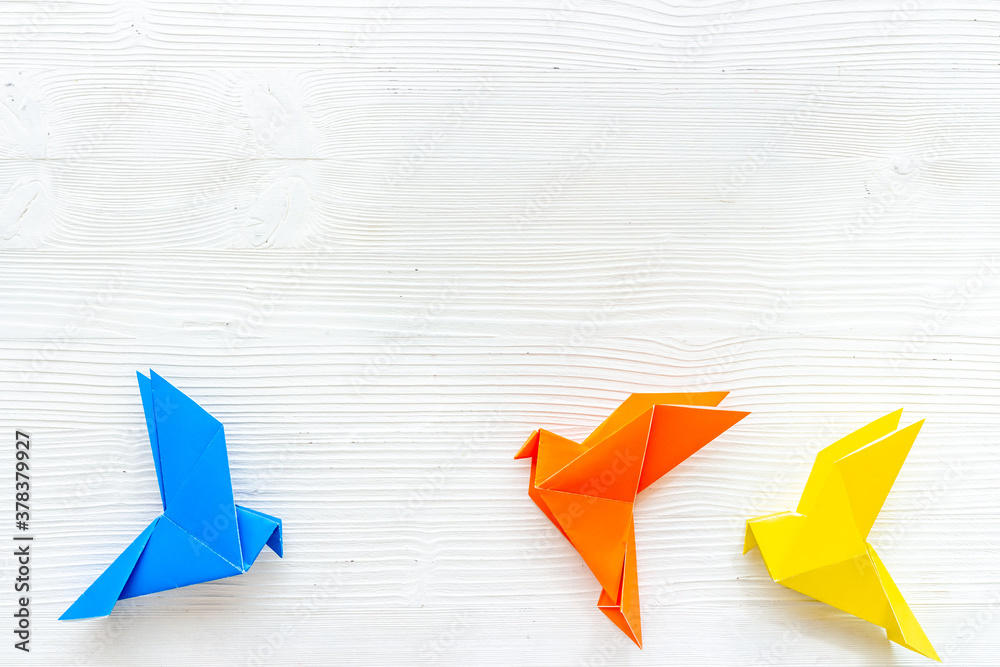 Paper birds of different shades. Origami concept. Top view