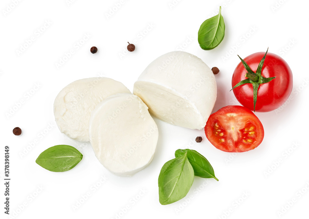 Pieces of mozzarella Buffalo cheese with basil leaves. Top view of sliced cheese with tomatoes isola