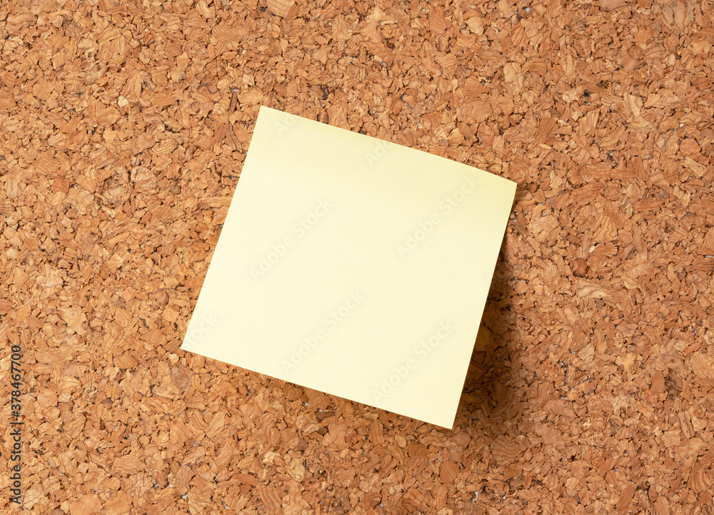 Yellow sticky note on corkboard