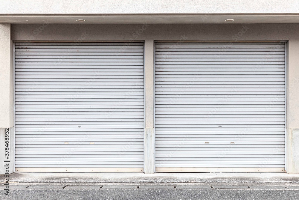 Automatic white roller shutter doors on the ground floor of the house