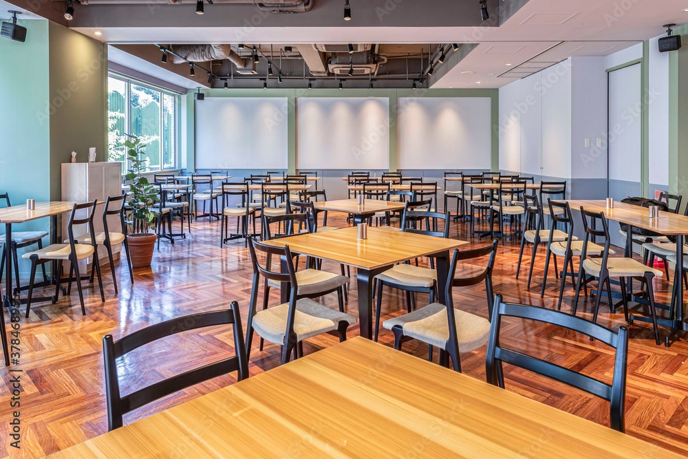 Empty tables and chairs inside  breakfast room in the hotel