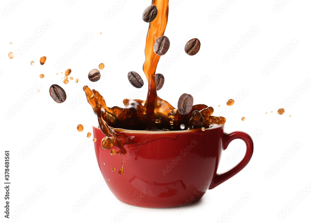 Pouring of hot coffee in cup and falling beans on white background