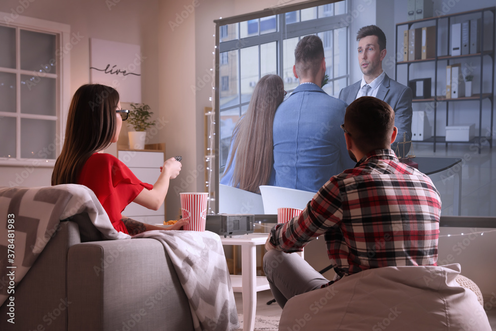 Young couple watching movie at home