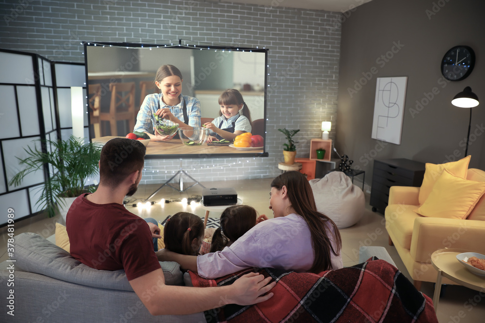 Young family watching movie at home