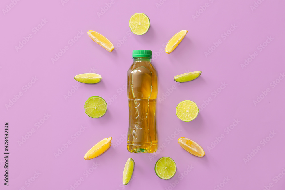 Bottle of fresh ice tea and ingredients on color background