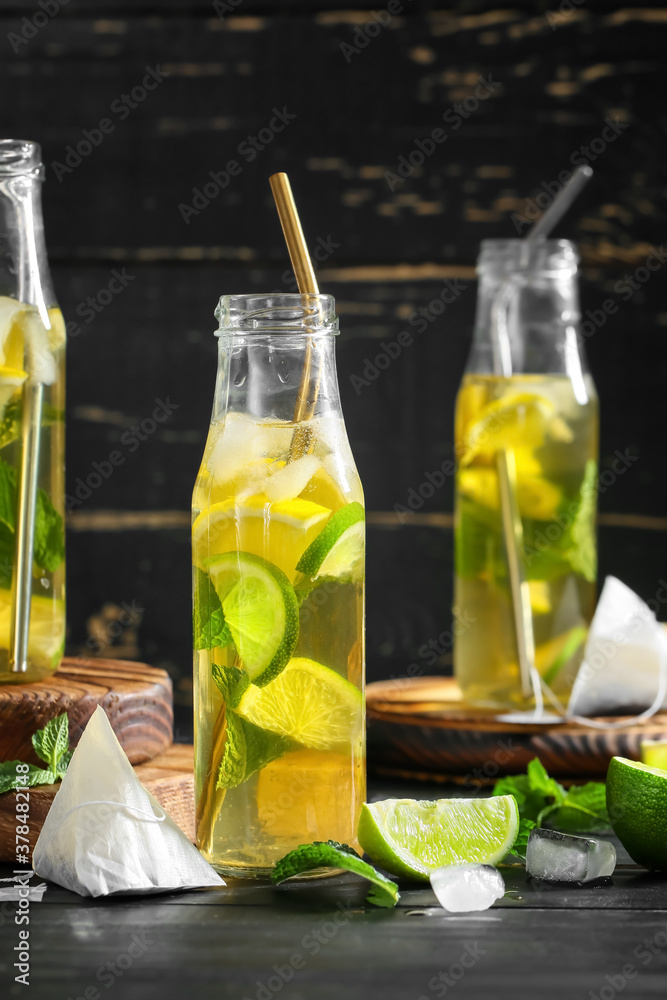 Bottles of fresh ice tea on dark background