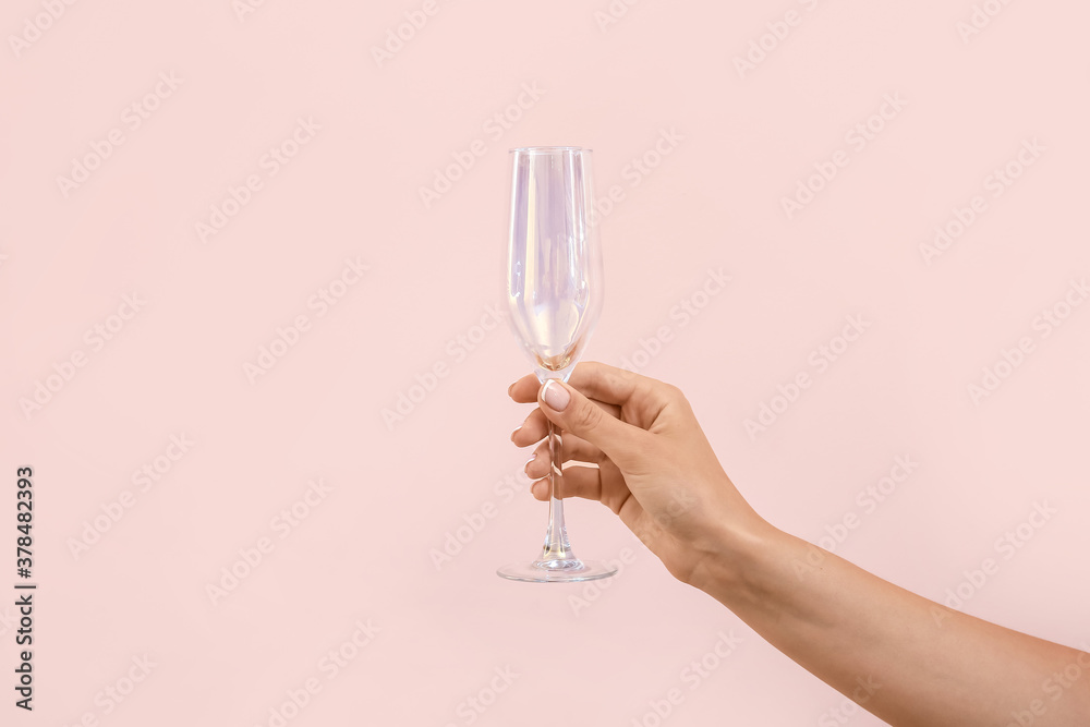 Hand with empty glass on color background