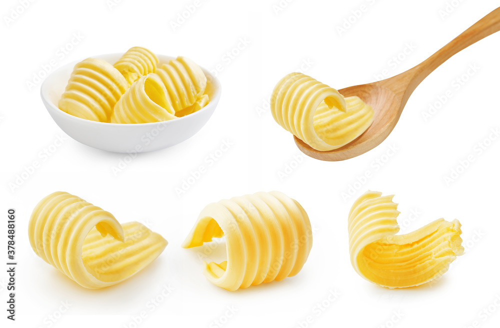 Set of butter curl on wooden spoon. Butter roll in white bowl isolated on white.