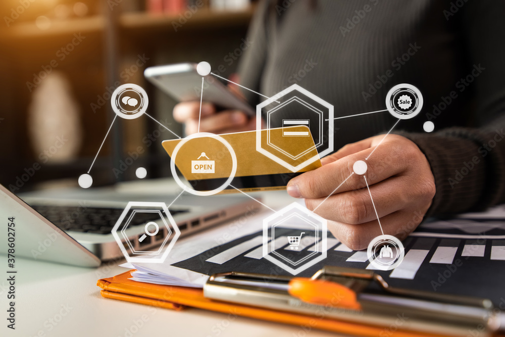 Close up of hand using tablet ,laptop, and holding mobile phone with credit card online banking paym