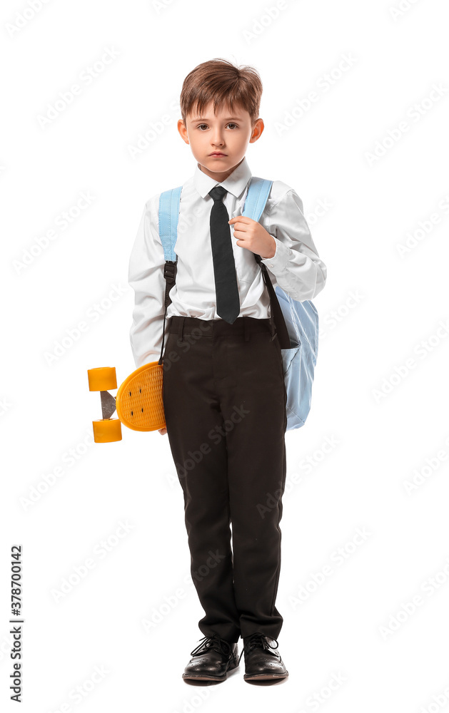 Little schoolboy with skateboard on white background