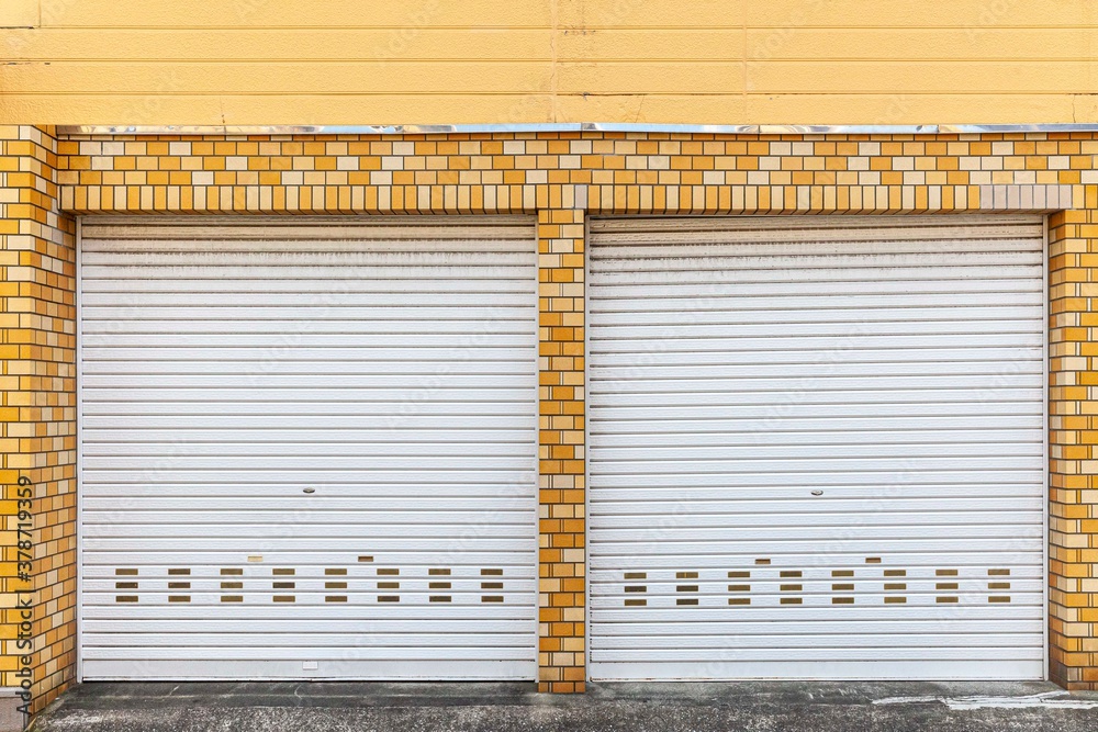 Automatic white roller shutter doors on the ground floor of the house