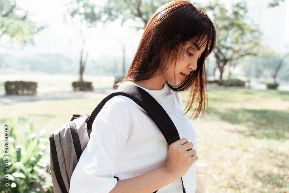 Side view - University student with a bag at park.