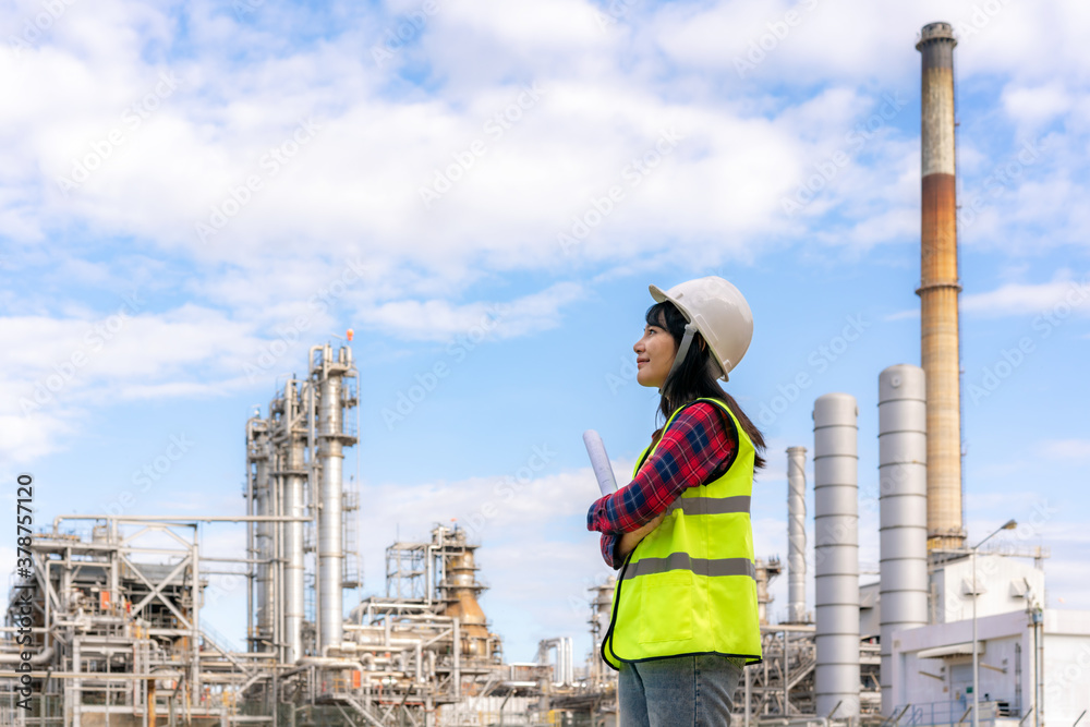 Asian woman engineer work control at power plant energy industry manufacturing oil refinery. Enginee