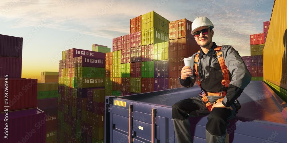 Happy Engineer sit in stack containers. His happy drinking coffee after successful work. Photo with 