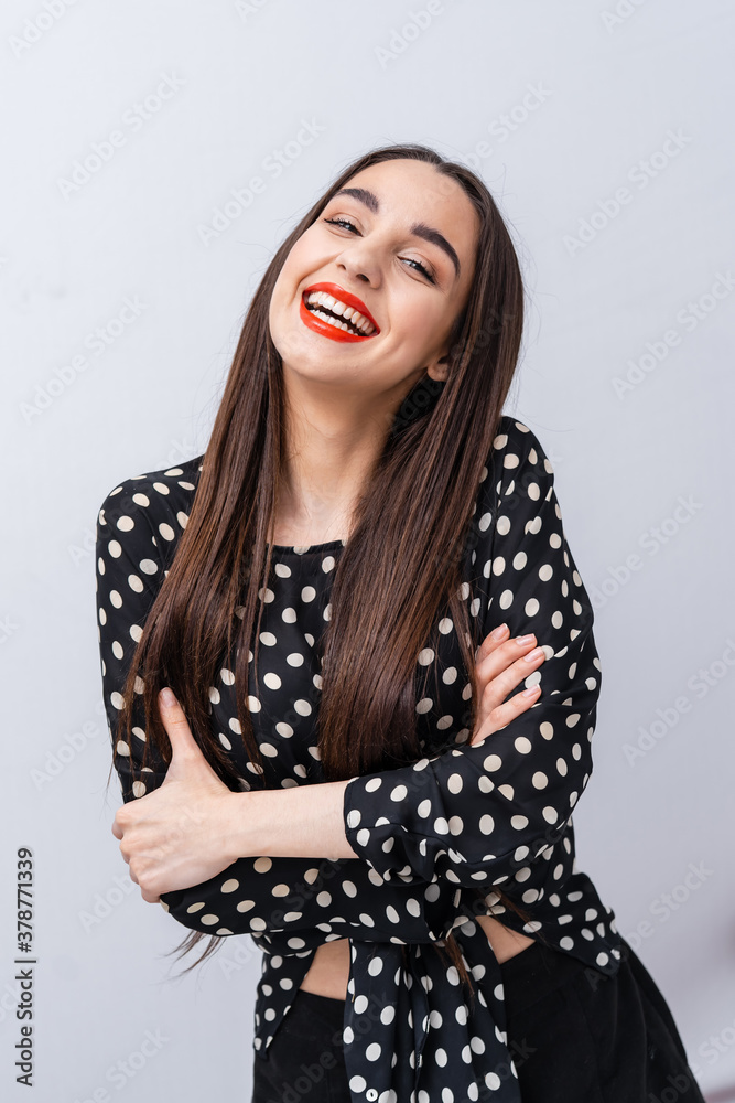 Smiling young woman with healthy teeth looks to the camera. Selective focus. Cropped photo. Girl hug