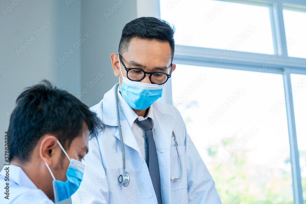 Group of doctor wearing protective surgical mask and discussing work together at the table during me