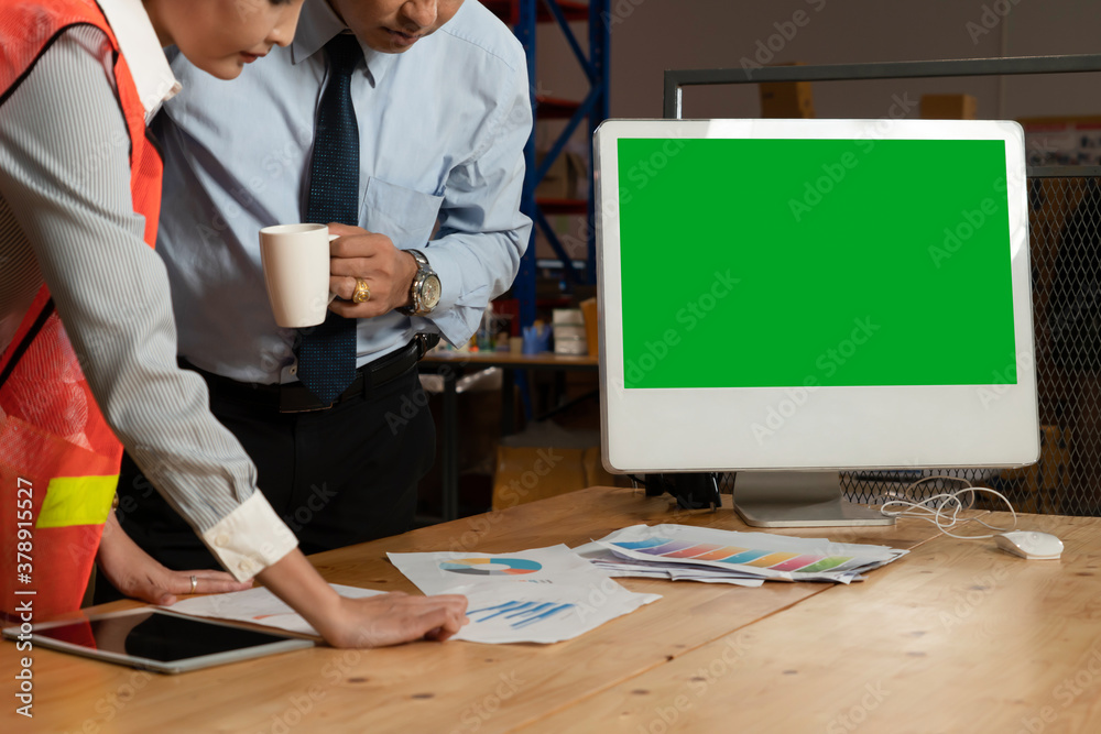 Computer with green screen display in warehouse storage room . Delivery and transportation software 