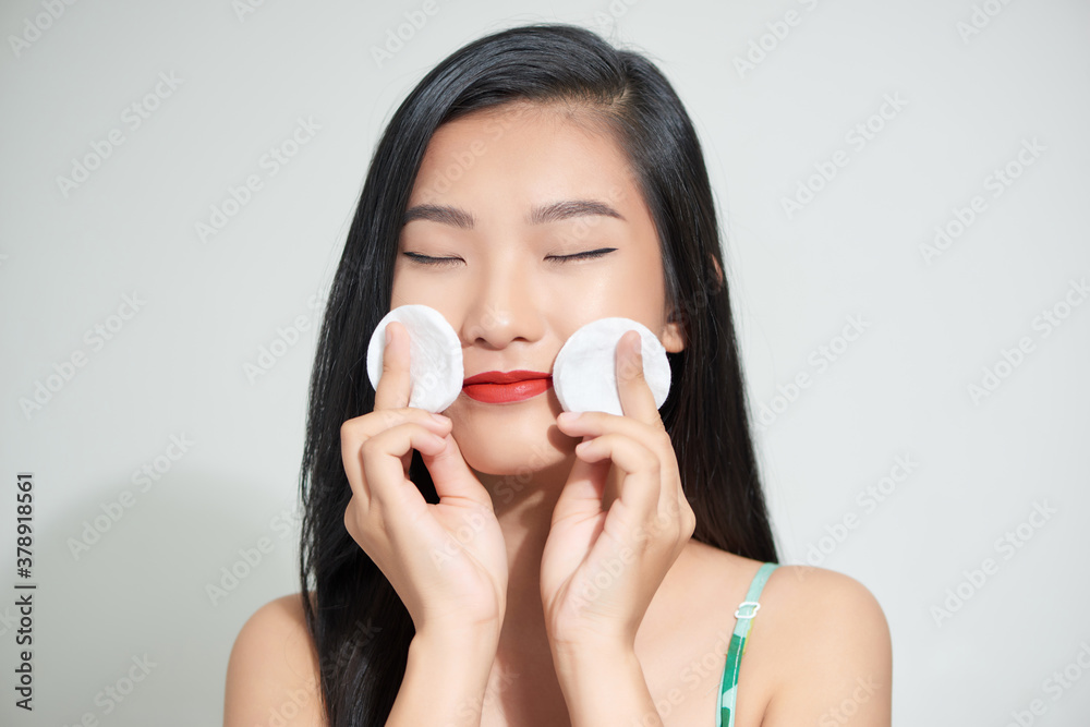 Young woman holding sponge in her hands isolated on white background