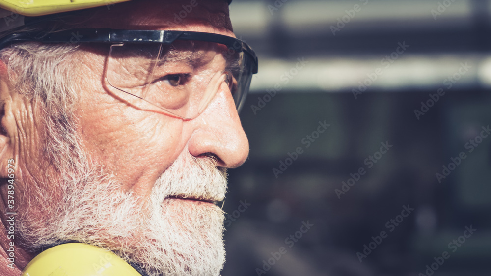 Senior factory worker or engineer close up portrait in factory . Industry and engineering concept .