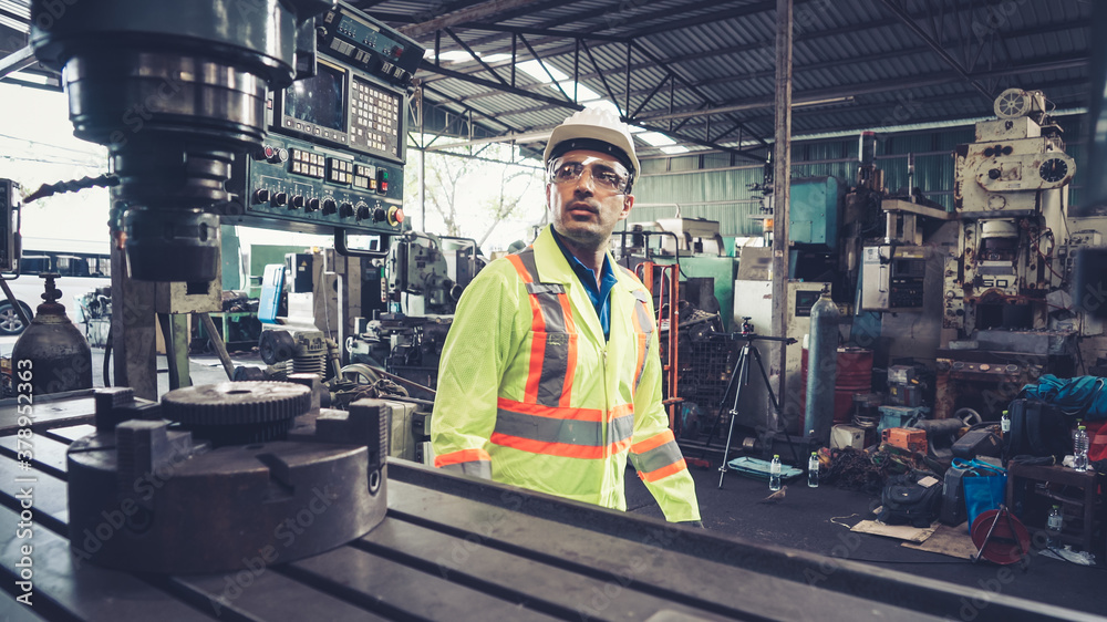 Smart factory worker using machine in factory workshop . Industry and engineering concept.