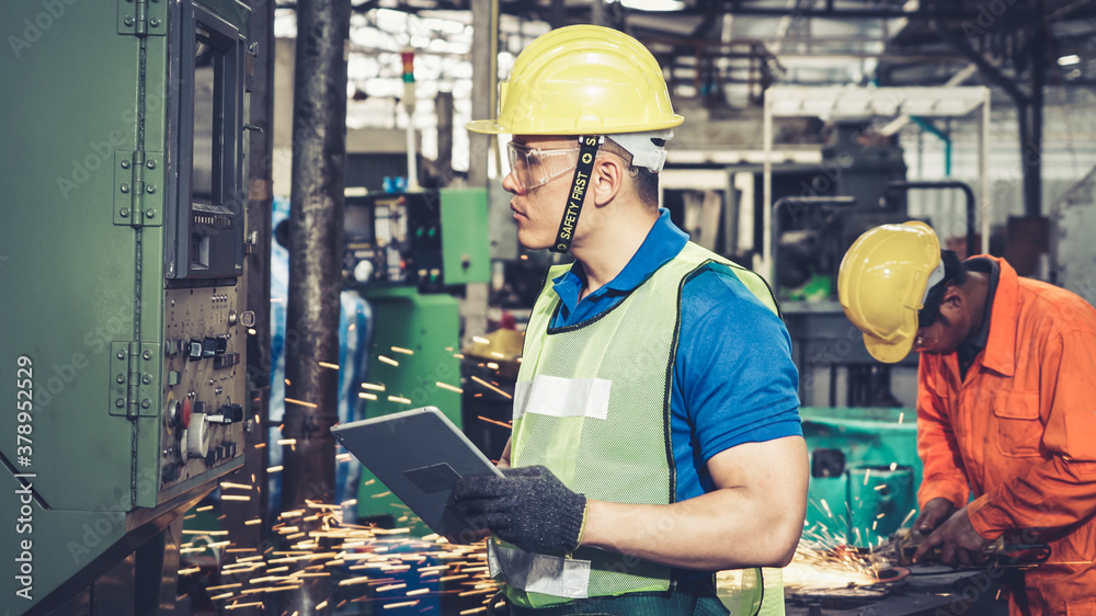 Smart factory worker using machine in factory workshop . Industry and engineering concept.