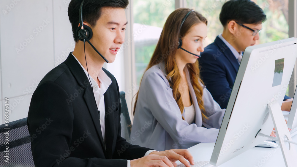 Business people wearing headset working in office to support remote customer or colleague. Call cent