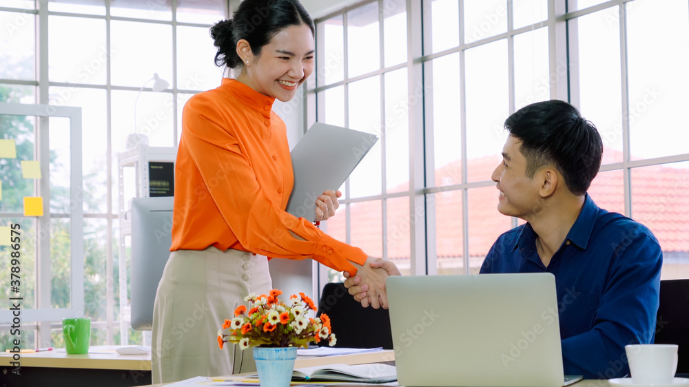 Business people handshake with friend at office showing trust , friendship and success celebration .