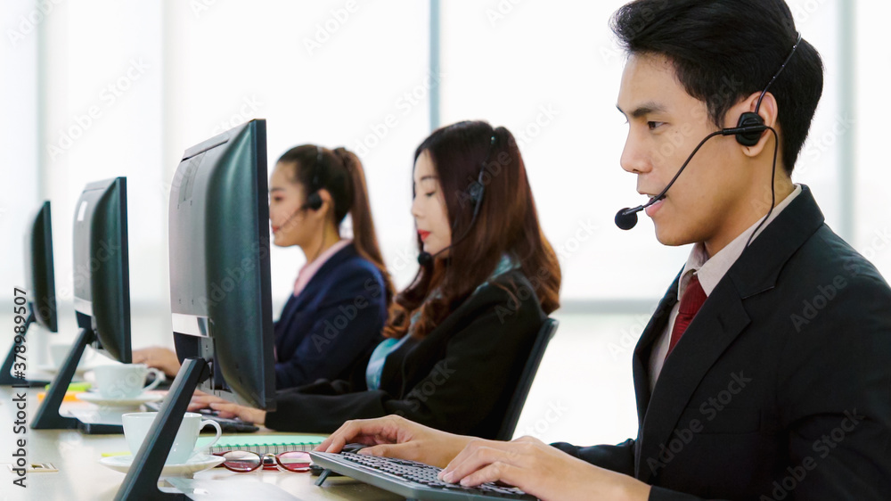 Business people wearing headset working in office to support remote customer or colleague. Call cent