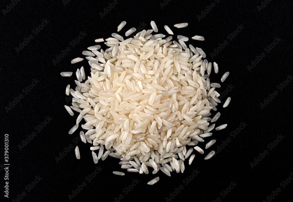 Heap of risotto rice isolated on black background