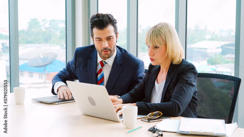 Two business people talk project strategy at office meeting room. Businessman discuss project planni