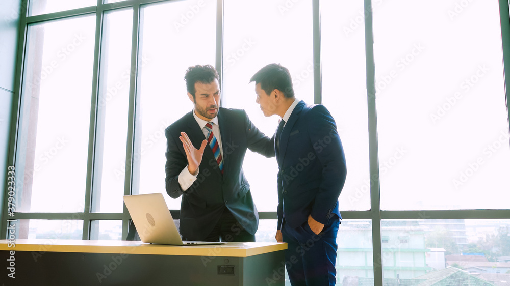 Two business people talk project strategy at office meeting room. Businessman discuss project planni