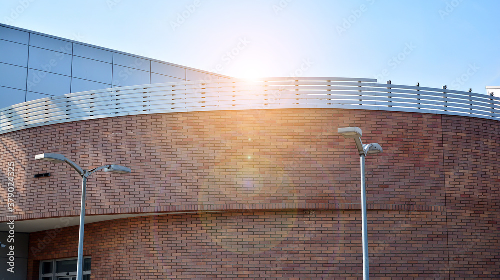 Office building, details of blue glass wall and sun reflections.