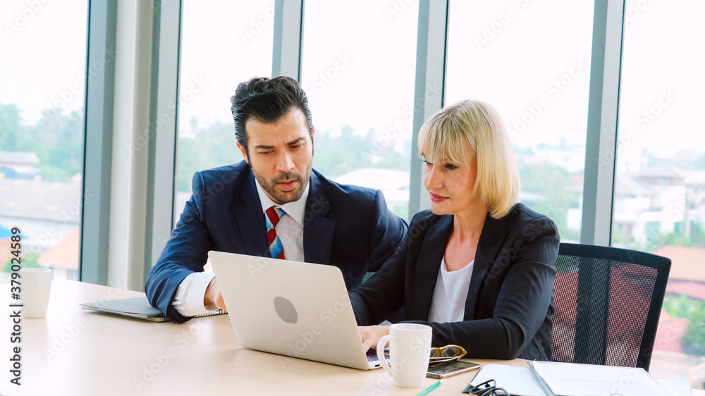 Two business people talk project strategy at office meeting room. Businessman discuss project planni