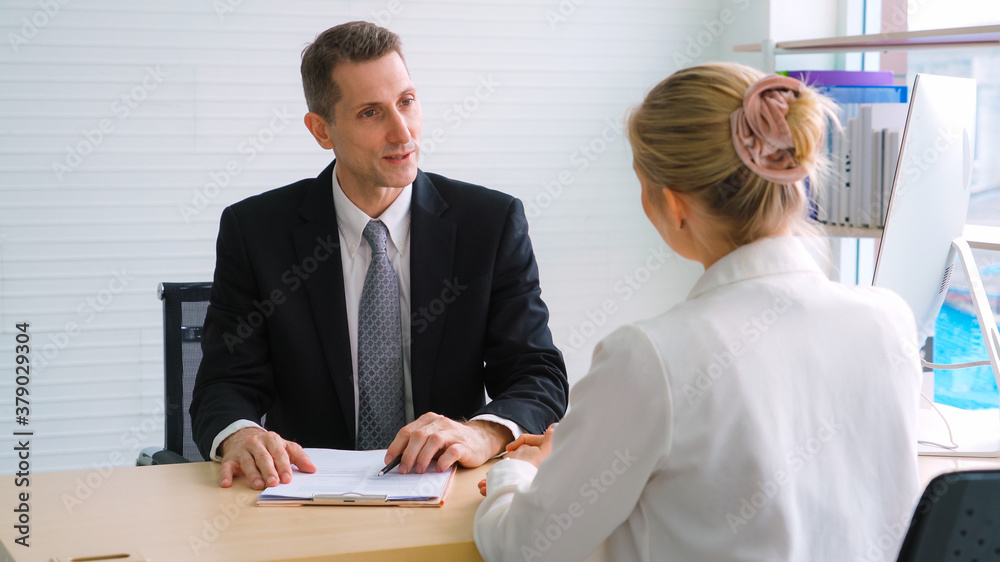 Job seeker in job interview meeting with manager and interviewer at corporate office. The young inte