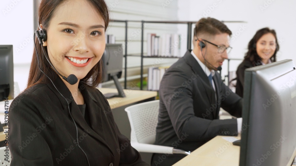 Business people wearing headset working in office to support remote customer or colleague. Call cent