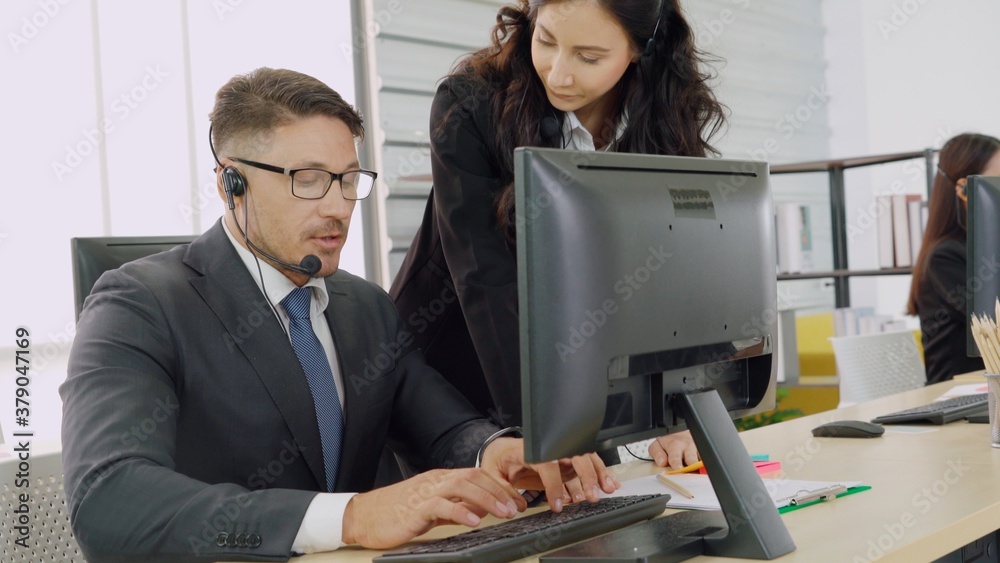 Business people wearing headset working in office to support remote customer or colleague. Call cent