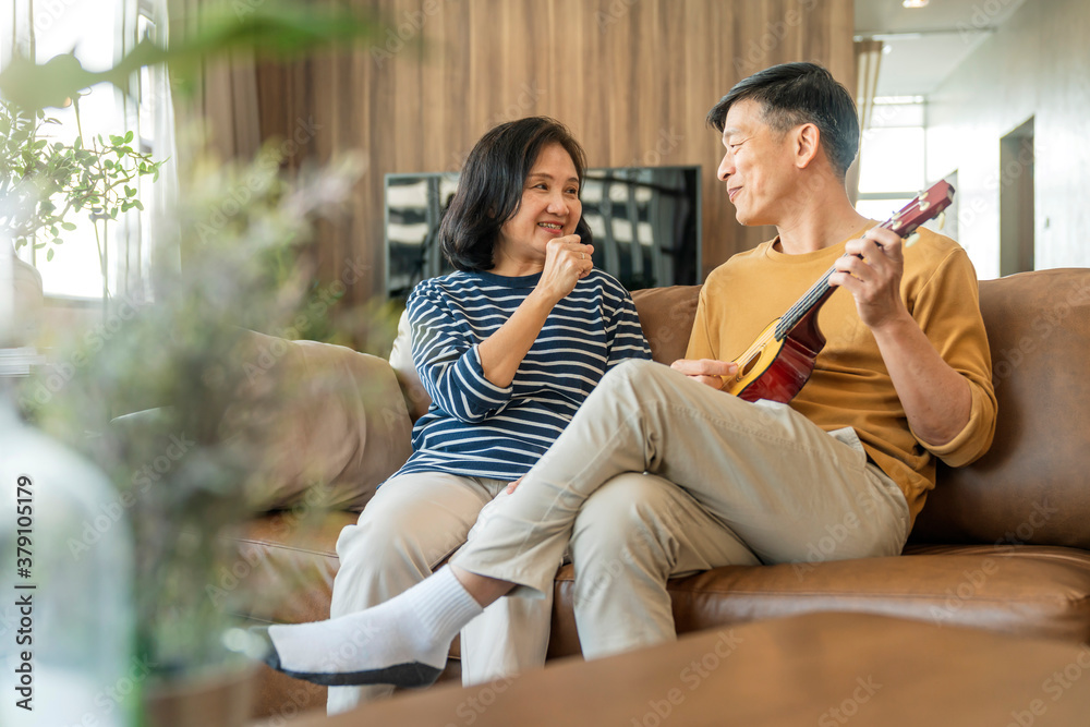 sweet Asian senior Couple sing play acoustic ukulele instrument. Happy Smiling Elderly grandparent h