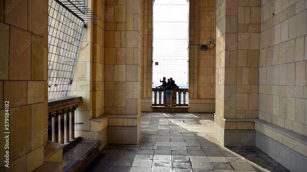 A lookout terrace on the 30th floor. People looking through barred windows on the terrace  located o