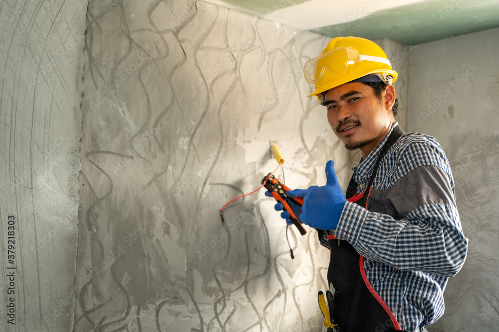 Electrician working with switches and sockets of a residential electrical system.