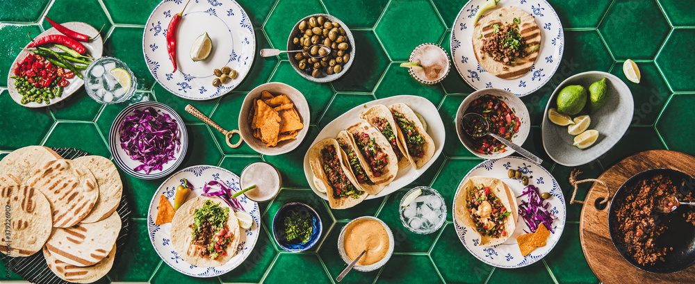 Family or friends home taco party. Flat-lay of Mexican traditional dishes Tacos with beef meat, corn