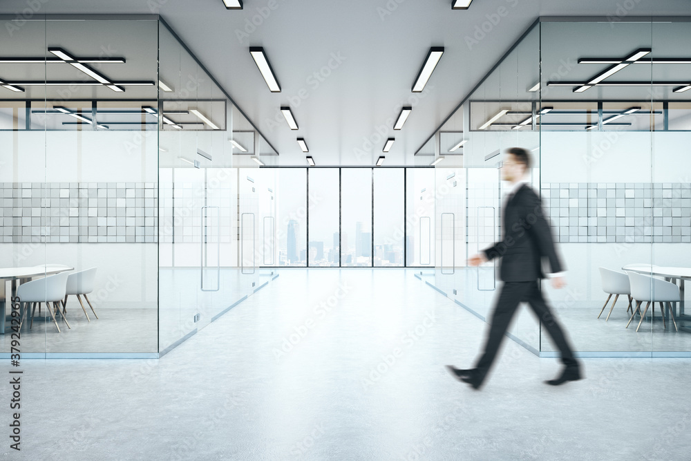 Businessman walking in office interior with abstract tiles on wall