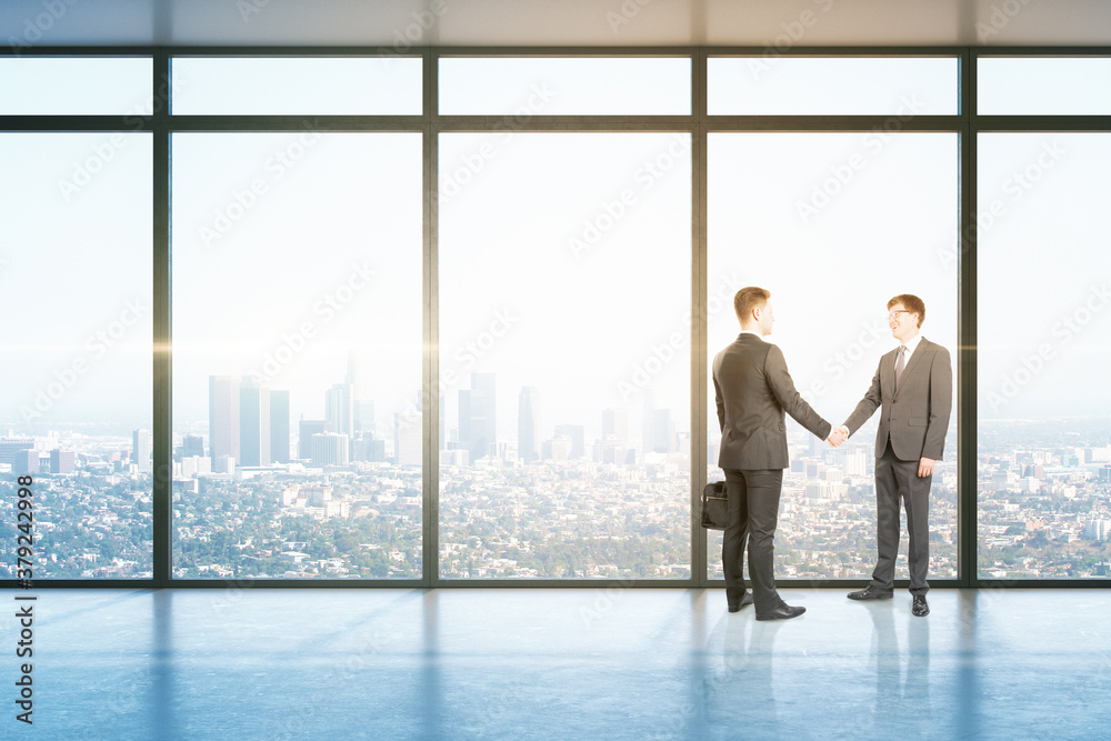 Business people handshaking in office hall