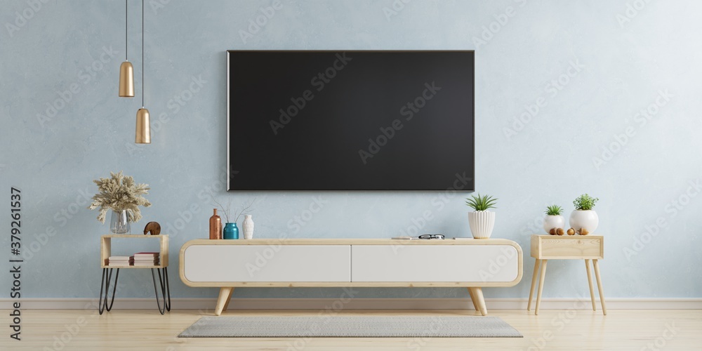 TV on the cabinet in modern living room on blue wall background.