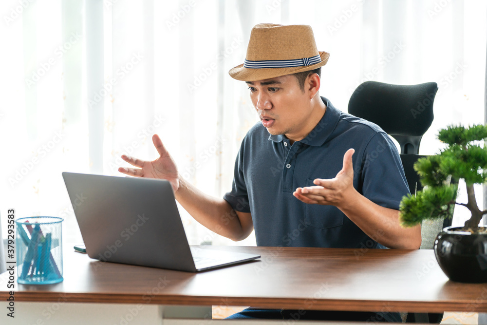 remote job, technology and people concept - stressed young asian man with laptop computer working at