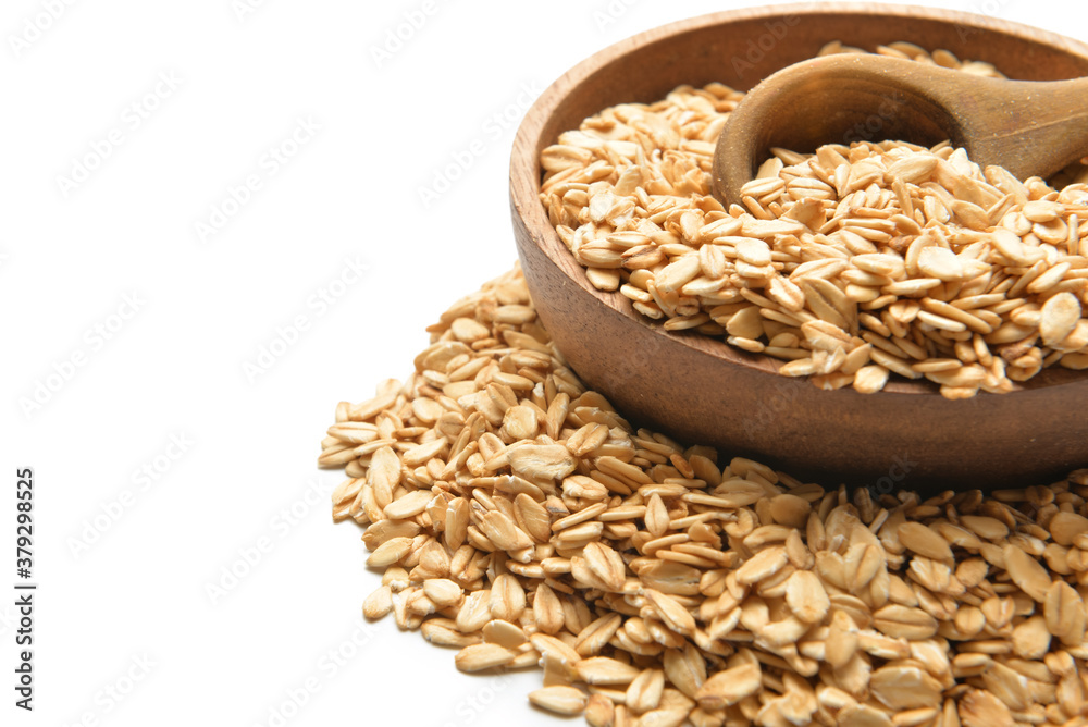 Plate with raw oatmeal on white background